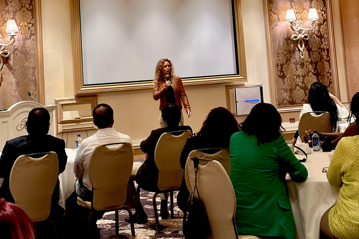 Erin Marie speaking to a room of attendees