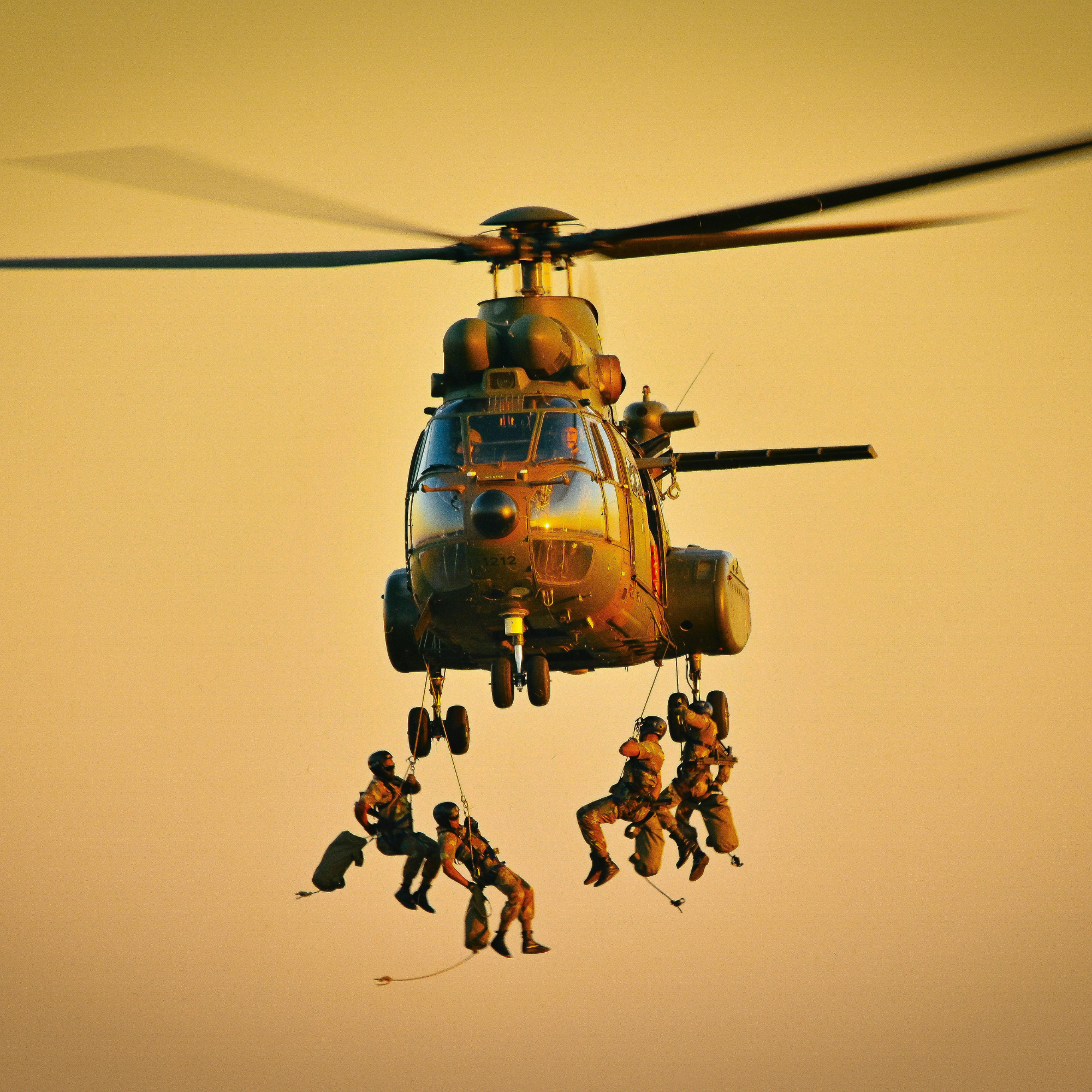 Special operations team rappelling from helicopter