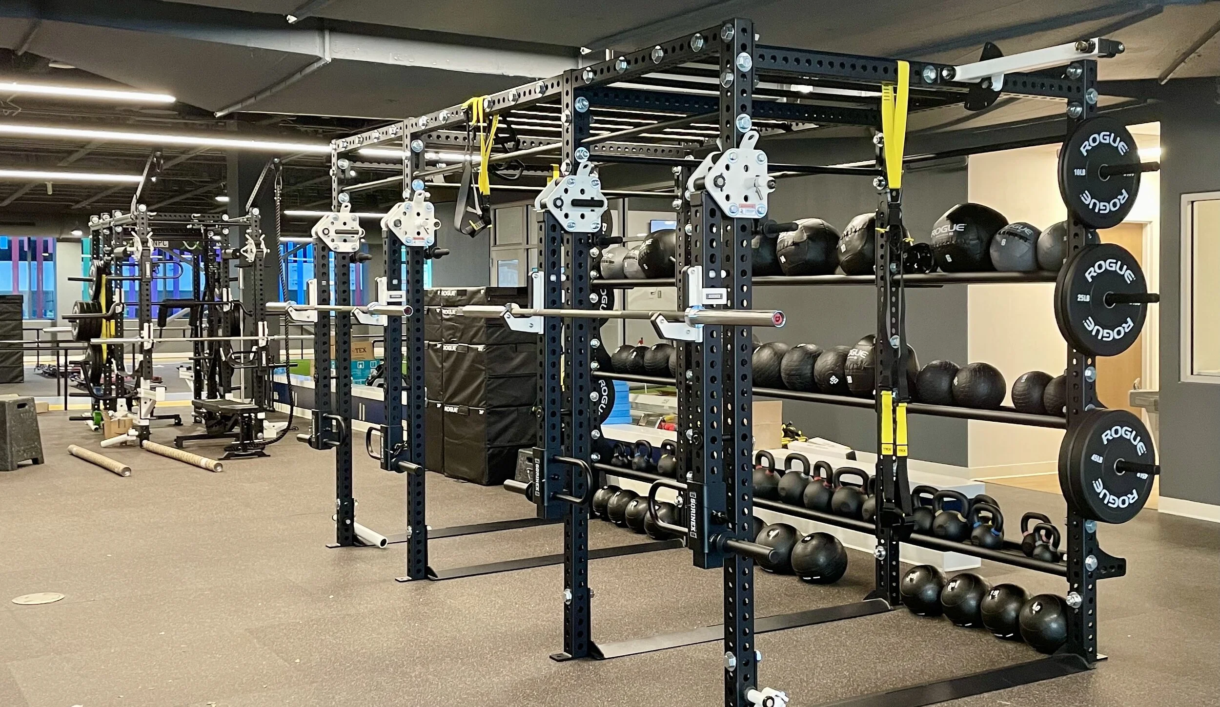 Full strength training rack and free weights at Lake Nona Performance Club